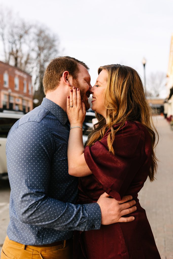 Man and woman about to kiss and smiling for their engagement session in Parkville, Missouri.