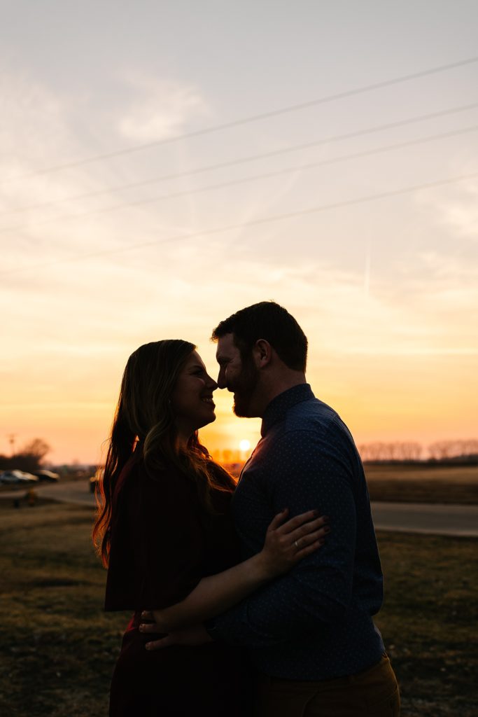 Silhouette of man and woman about to kiss in the sunset. 