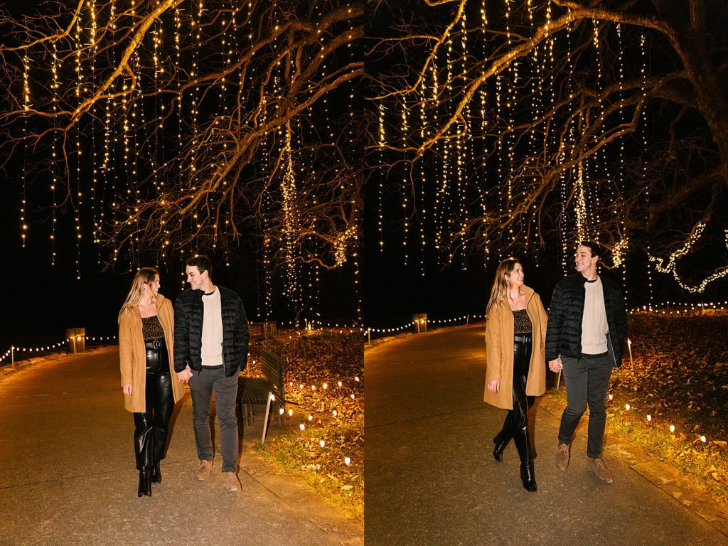 Newly engaged couple walking through lights after their Christmas lights proposal. 