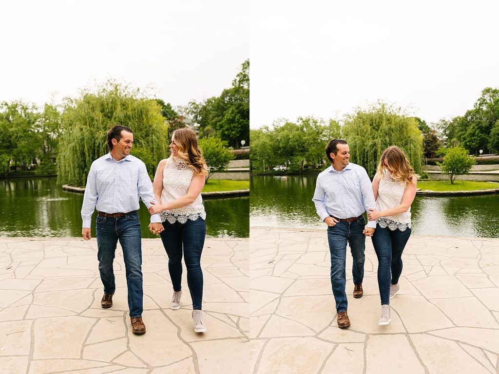 Couple walking in front of a pond at Loose Park for their engagement photo shoot.