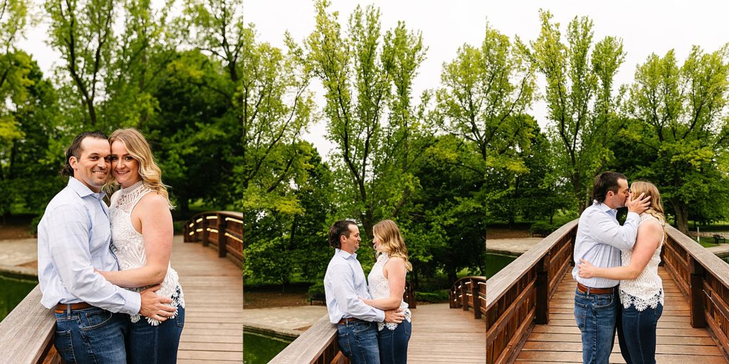 Couple hugging on a bridge in the middle of Loose Park for their engagement session. 