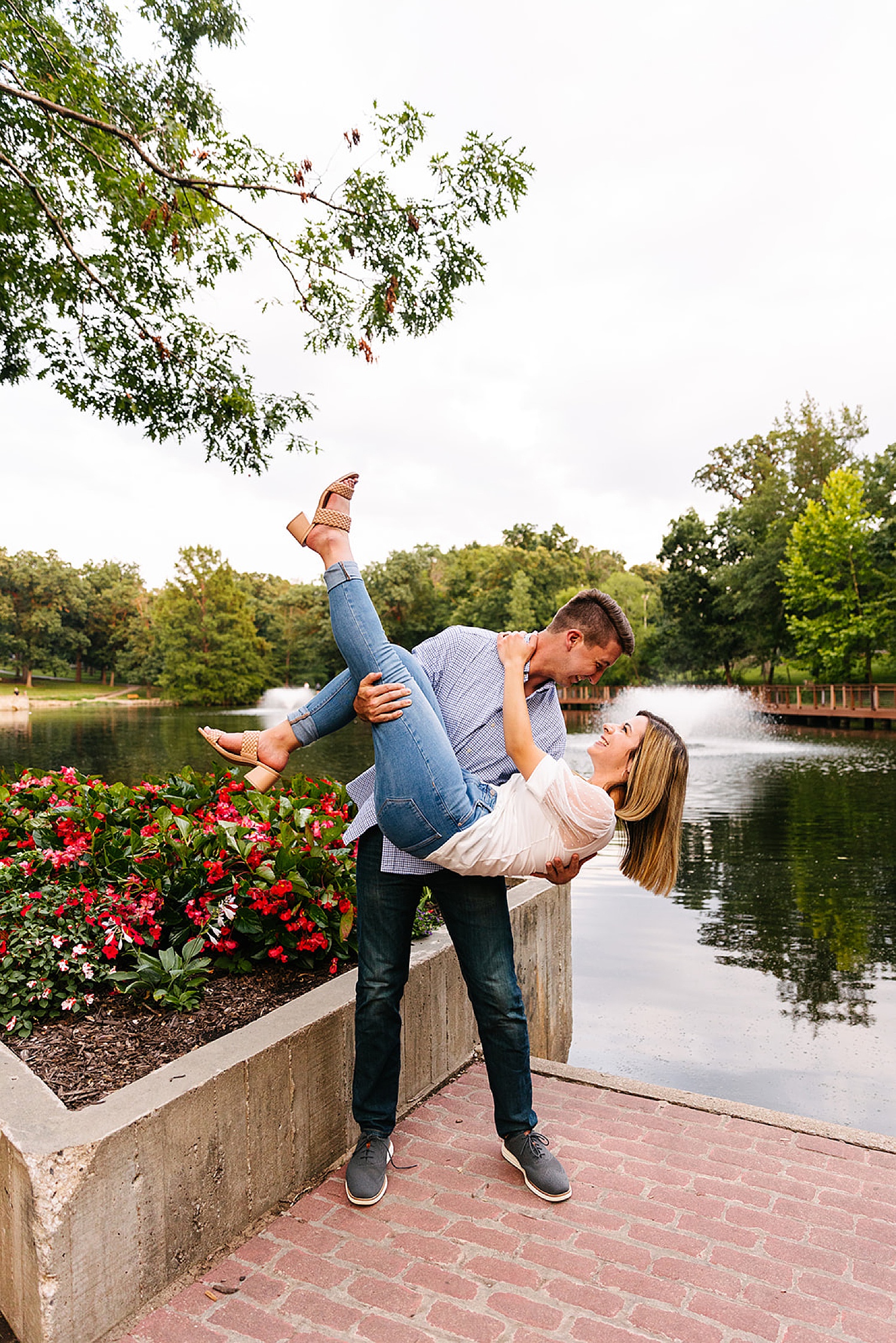new engaged couple smiling at one another with Kansas City engagement photographer