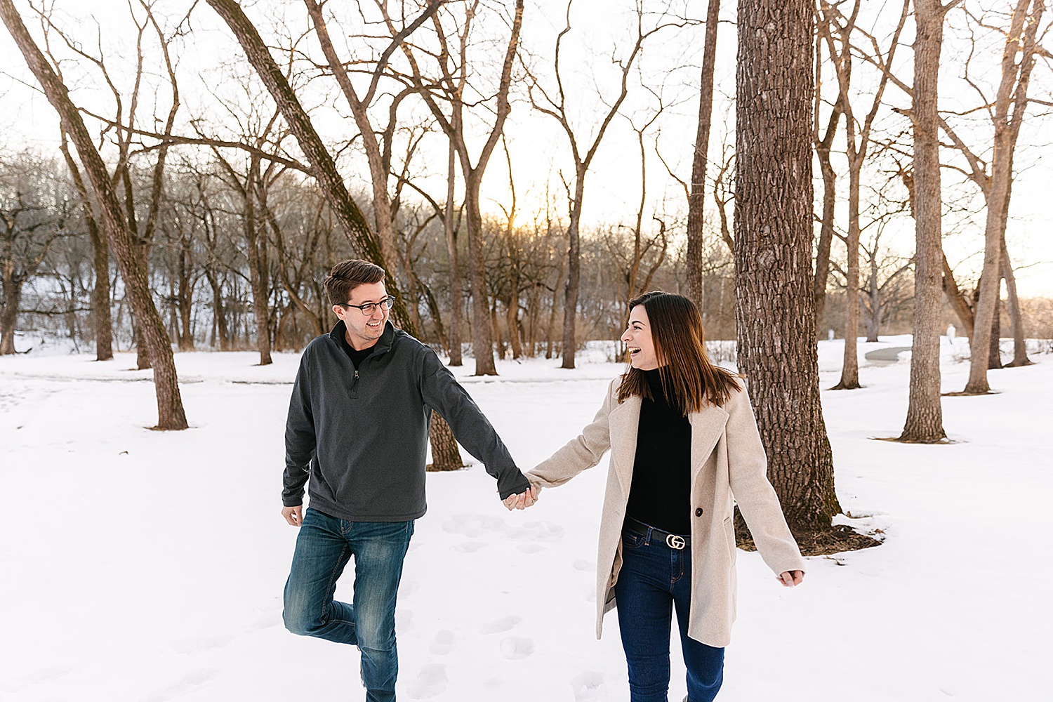 engaged couple laughing in park with Kansas City photographer