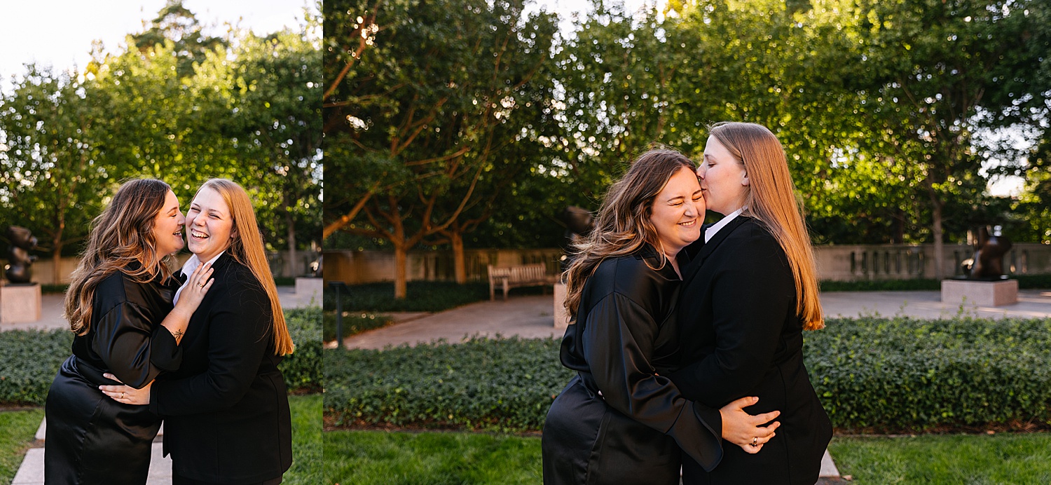 Couple wearing black suit and black dress giving forehead kisses during engagement session