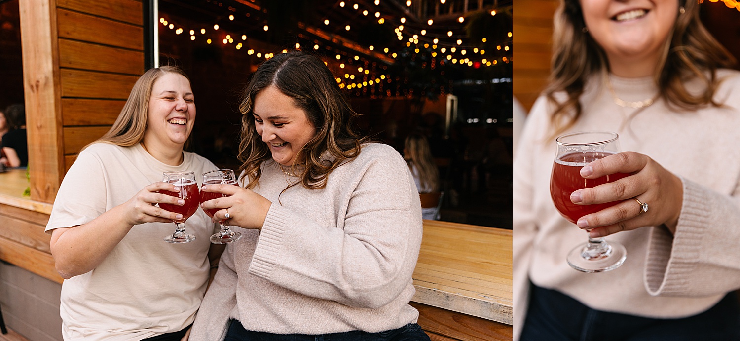 Couple shares of beer at casual animal brewery during engagement session showing off diamond engagement ring