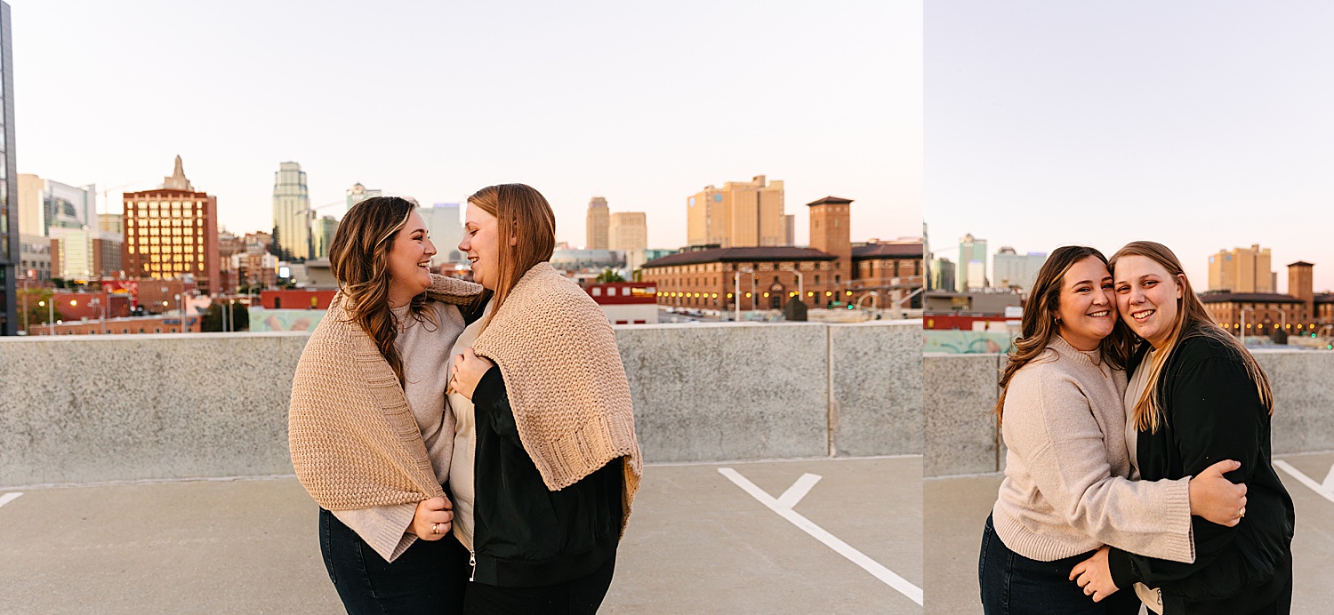 Engaged women rather each other in blanket overlooking Kansas City skyline