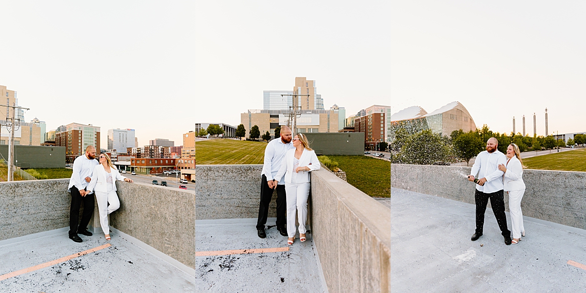 couple popping bottle of champagne during modern engagement session with fiancé in white dress shirt 