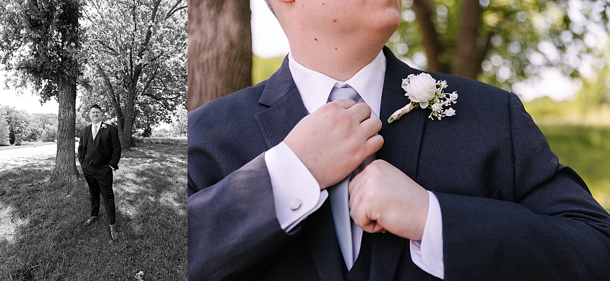 groom holding tie in portrait at wedding venue by Natalie Nichole photography 